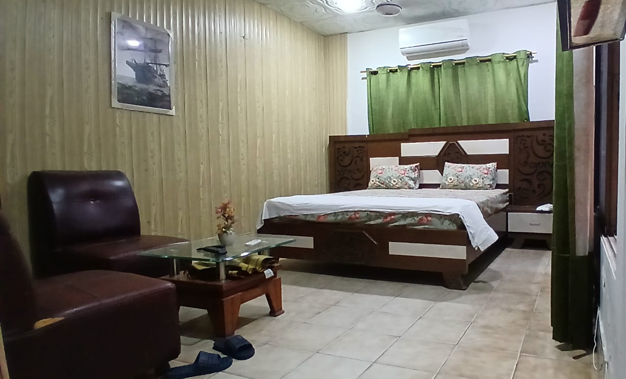 Deluxe Room with carved wooden bed